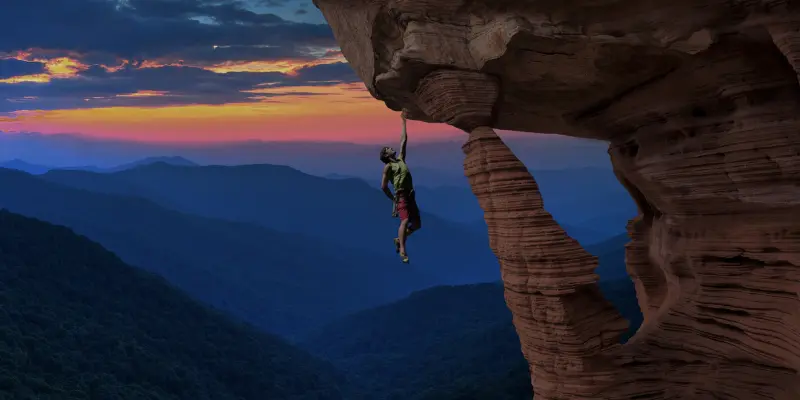 Climber Hanging Rocky Cliff Sunset Mental Toughness Alt text should be clear, concise, and descriptive, focusing on the content and context for both SEO and accessibility.
